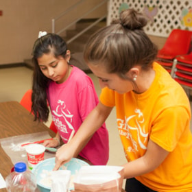Girls on the Run coach and participant work on their community impact project.