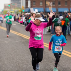 Girls on the Run participants cross the finish line at the South Bend 5K.